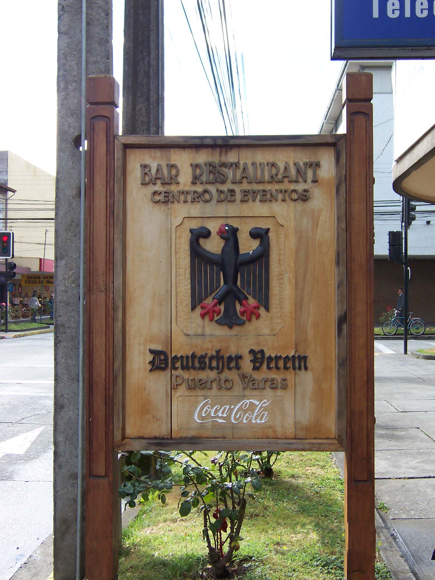 Wood-carved street sign beckoning diners to the Club Alem&aacute;n's bar and restaurant. The German eagle greets Atlanta's global beverage in South America